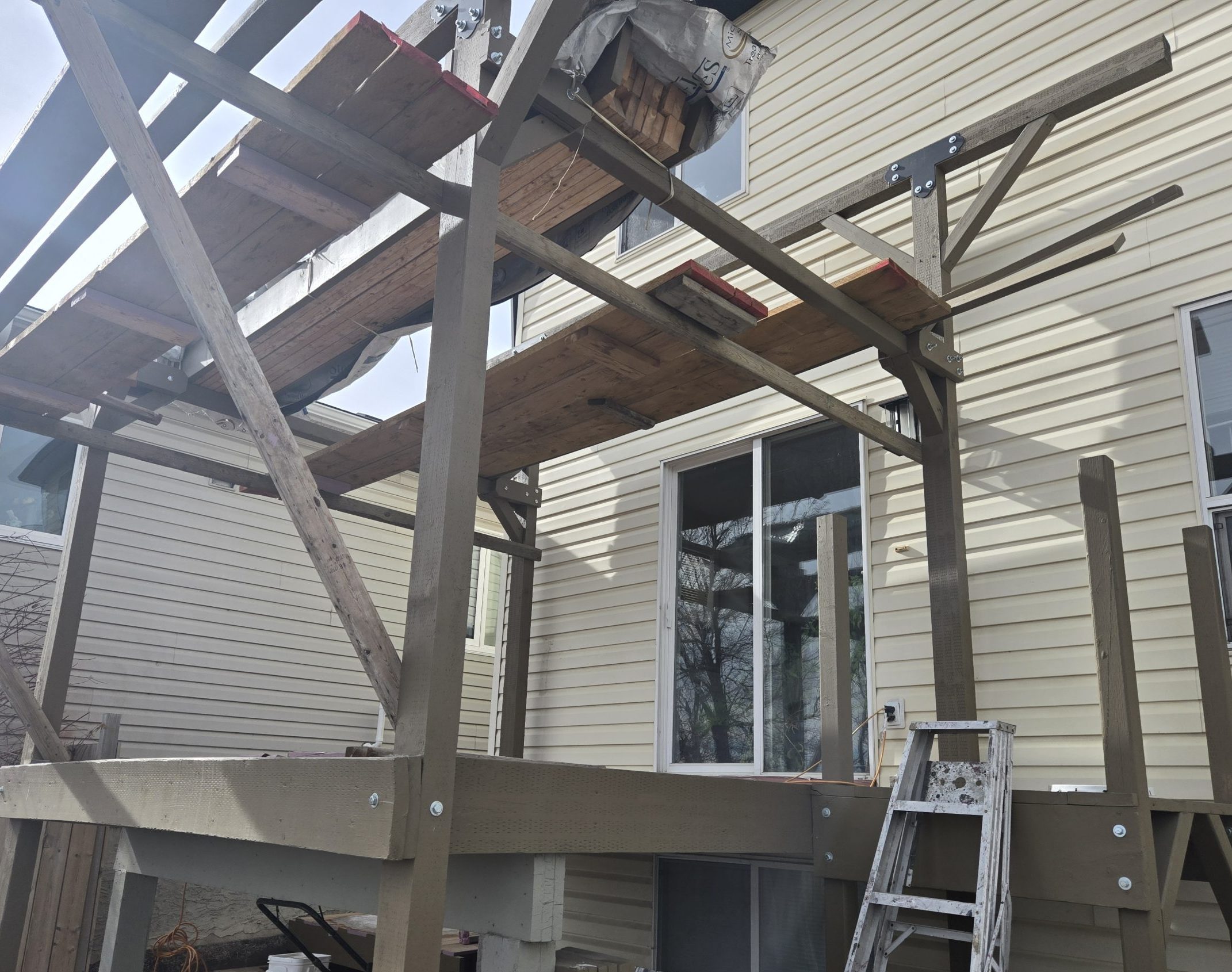 Three-season sunroom under construction, structural framing and load transfer, Calgary